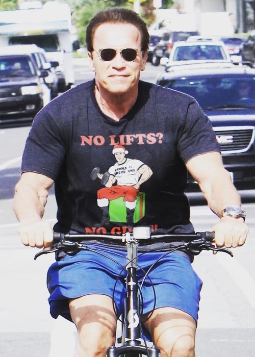 Arnold Schwarzenegger riding a bike